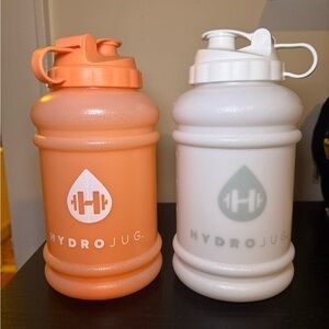 Hydrojug Bottles. White is brand new and orange has been used twice.